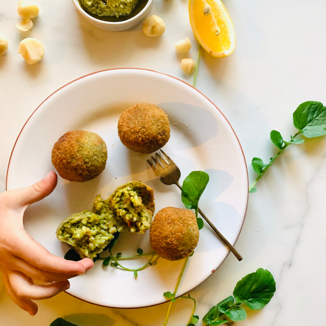 Gluten-free, Low FODMAP vegan basil and macadamia arancini on plate.