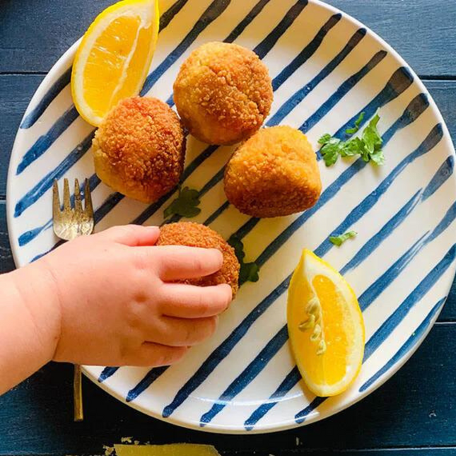 Gluten-free, Low FODMAP (onion & garlic free) beef bolognese and mozzarella arancini on plate.