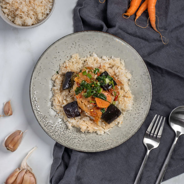 A plate of Gluten-free, lactose-free fish red curry with coconut rice.