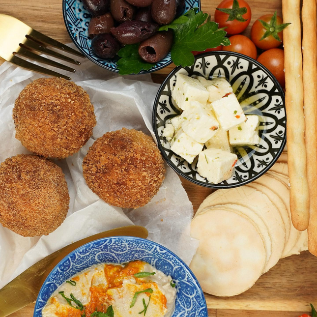 Pumpkin and feta arancini which are Gluten-free, Low FODMAP, vegetarian arancini on plate.