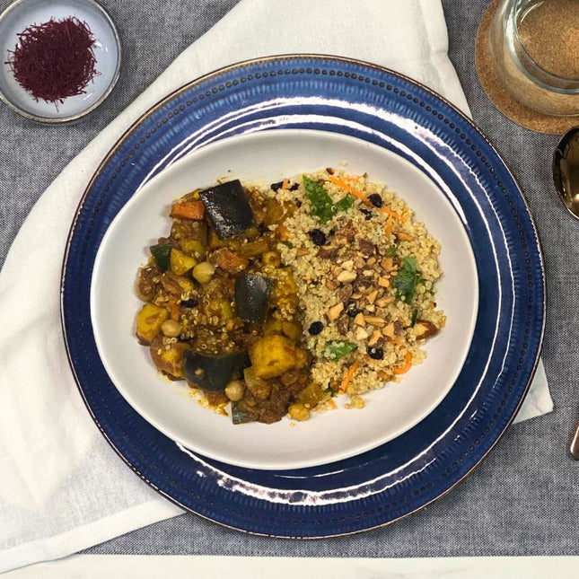 A plate of Moroccan vegetable stew with quinoa, garnished with nuts and herbs. Gluten-free, Low FODMAP  and vegan.
