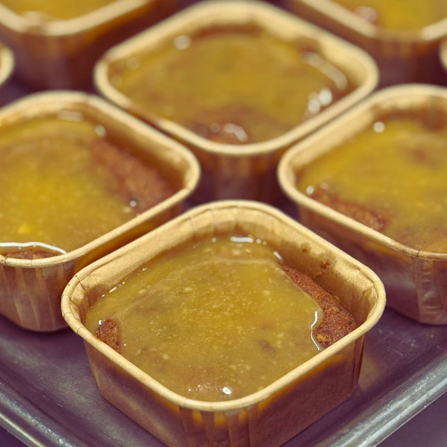 Gluten-free, low FODMAP sticky date puddings by We Feed You, rich, moist and served with caramel sauce.