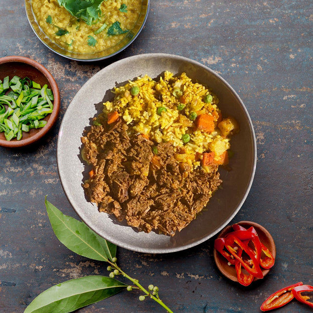 Beef Rogan Josh ready meal which is gluten free. Served in a bowl with rice. 