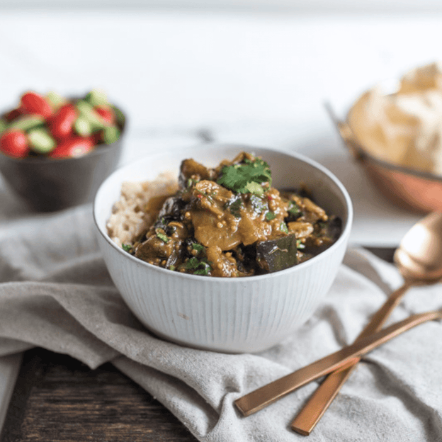 Tamarind Eggplant Curry w/ Cherry Tomatoes & Brown Rice in bowl.  This 375g serve is Gluten Free, lactose free and vegan.